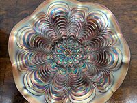 Top view showing the peacock tail feather pattern and iridescent finish on the carnival glass bowl.