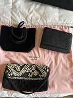 Three small black handbags on a pink Kate Spade dust bag, showing the designs and condition of each bag.