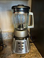 Front view of Cuisinart blender assembled with glass jar on base showing control buttons and handle