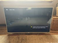 Front view of Sony BRAVIA 43 inch TV powered on showing HDMI 1/MHL input with no signal message on screen