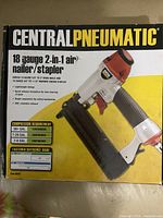 Photo of the Central Pneumatic air nailer/stapler in original box showing front of packaging with product image and features.