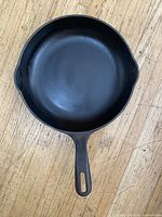 Top view showing the smooth flat cooking surface and handle of the skillet.