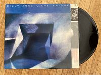Billy Joel The Bridge album cover and partially visible vinyl record.
