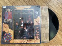 Photo of the Duran Duran 7-inch vinyl single and The Ragged Tiger vinyl album showing cover art and vinyl records partially visible.