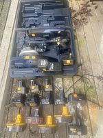 Photo of Mastercraft cordless power tools including jigsaw, drill, circular saw inside carrying case with various batteries laid out below.