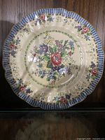 Front view of the Royal Doulton The Vernon dinner plate showing floral design and scalloped edge