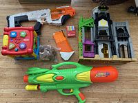 Overview of toys including two water shooters, Batman play structure, activity cube and accessories.