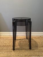 Front angled view of the Kartell Charles Ghost Stool showing overall shape and leg design