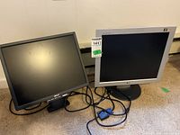 Both Acer AL1706 and LG Flatron L1752S monitors shown side by side with cables visible, placed on carpeted floor.