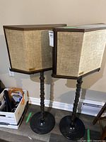 Front view of both speakers on stands against wall