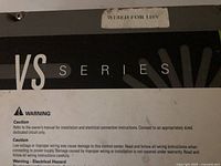 Close-up of the label showing 'VS Series' and electrical caution warnings on the spa control system.