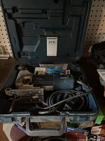 Bosch 1584AVS jigsaw in case with power cord and accessories packed inside.