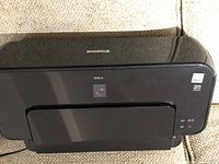 Canon iP1800 printer closed view on beige fabric surface