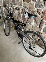Full side view of the Cherokee Climber mountain bike showing blue and silver frame, knobby tires, saddle, and handlebars.
