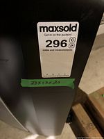 Side view of the black Haier air conditioner with measurement label showing 33x12x20 inches.