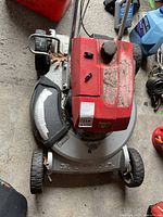 Top view of red and silver Honda HR21 push lawn mower showing overall condition and visible wear.