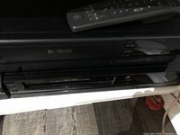 Side and partial upper view with remote control on top showing product placement and condition