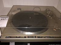 Full view of the Pioneer turntable with dust cover showing control buttons and tonearm.