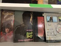 Front covers of 4 vinyl albums including Electric Ladyland by Jimi Hendrix, an original motion picture soundtrack by Jimi Hendrix, and two Bob Marley & The Wailers albums including Babylon By Bus.