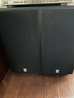 Pair of Derwin-Vega VS Series speakers side by side showing black fabric covers and minor wear.