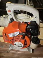Front side view showing orange recoil housing, Stihl BG 55 label and pull starter handle.