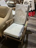 Lounge chair with cushions on slatted seat and back