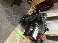 Full side angle view of the Tecumseh motor showing the pull-start recoil and overall housing condition on workshop floor.