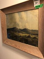 Framed landscape watercolor painting angled view showing mountains and field detail
