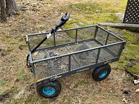 Side view of the Yardworks garden cart showing metal mesh sides, solid frame, blue-rimmed pneumatic wheels, and handle.