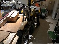 Front three-quarter view of motorcycle on crate