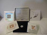 Photo of full set coins and stamps with display packaging and certificates.