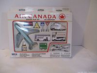 Photo showing the full unopened Air Canada Airport Play Set in its original box, displaying the die-cast airplane and several vehicles and signs.