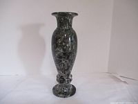 Front view of the black marble vase showing the full height and shape.