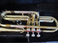 Image of the Conn brass trumpet showing the three piston valves and part of the tubing, highlighting condition and finish.