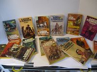 A set of 16 Louis L'Amour paperback books with Western-themed covers, arranged in two rows showing variety of titles and cover art.