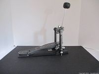 Side view of Ludwig bass drum pedal showing footboard, spring tension mechanism, and attached beater with felt head.