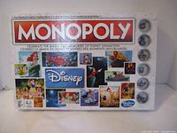 Front of the Monopoly Disney board game box showing main logo, Disney animation images, and age recommendation.