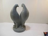 Front angled view of the gray outdoor dove statue showing both doves facing inward.