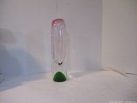 Front view of the clear glass vase showing green base and pink top gradient