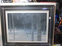 Front view of framed print showing wolf in snowy forest and overall frame