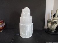 Selenite stone lamp unlit, showing natural crystalline tiered form, translucent white color, approx 8.5 inches tall