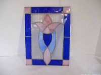 Front view of stained glass sun catcher showing colorful glass inset in metal framework