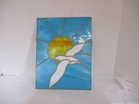 Full view of the stained glass sun catcher showing the entire design and colors.