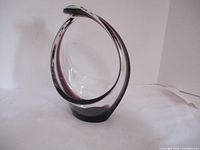 Front view of the vintage purple art glass bowl showing the swirled purple core and fluid organic shape.