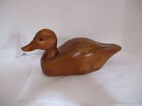 Wooden duck carving side view showing shape and finish