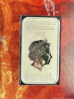 Obverse photo showing Queen Elizabeth II portrait and inscriptions indicating Australian origin, year 2009, denomination 1 dollar, and silver purity and weight.