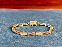 Front view of the silver tennis bracelet laid flat showing paste stones and spacers.