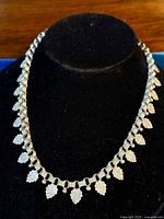 Full view of necklace draped on black bust stand