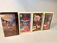 Four vintage horror movie VHS tapes in hard shell rental cases. Titles are Asylum: The House of Crazies, Tales from the Darkside: The Movie, The Company of Wolves, and Creature of the Night.