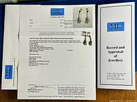 Appraisal certificate and cover showing earrings and appraisal details